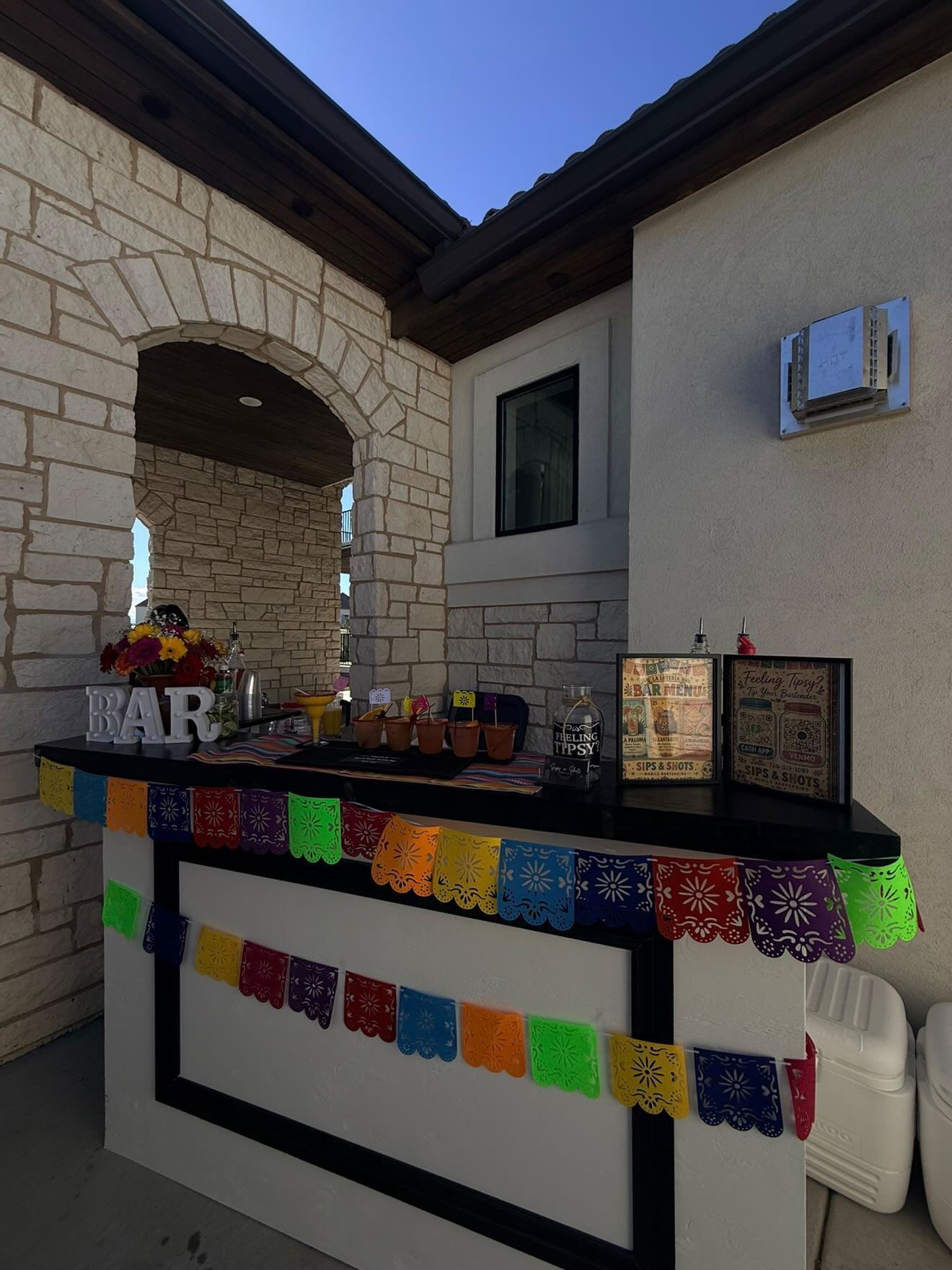 Sips & Shots bar set up outdoors for a fiesta-themed event